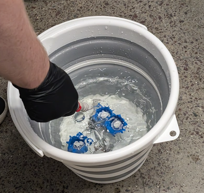 soaking blue flavor connectors in chlorine solution bucket